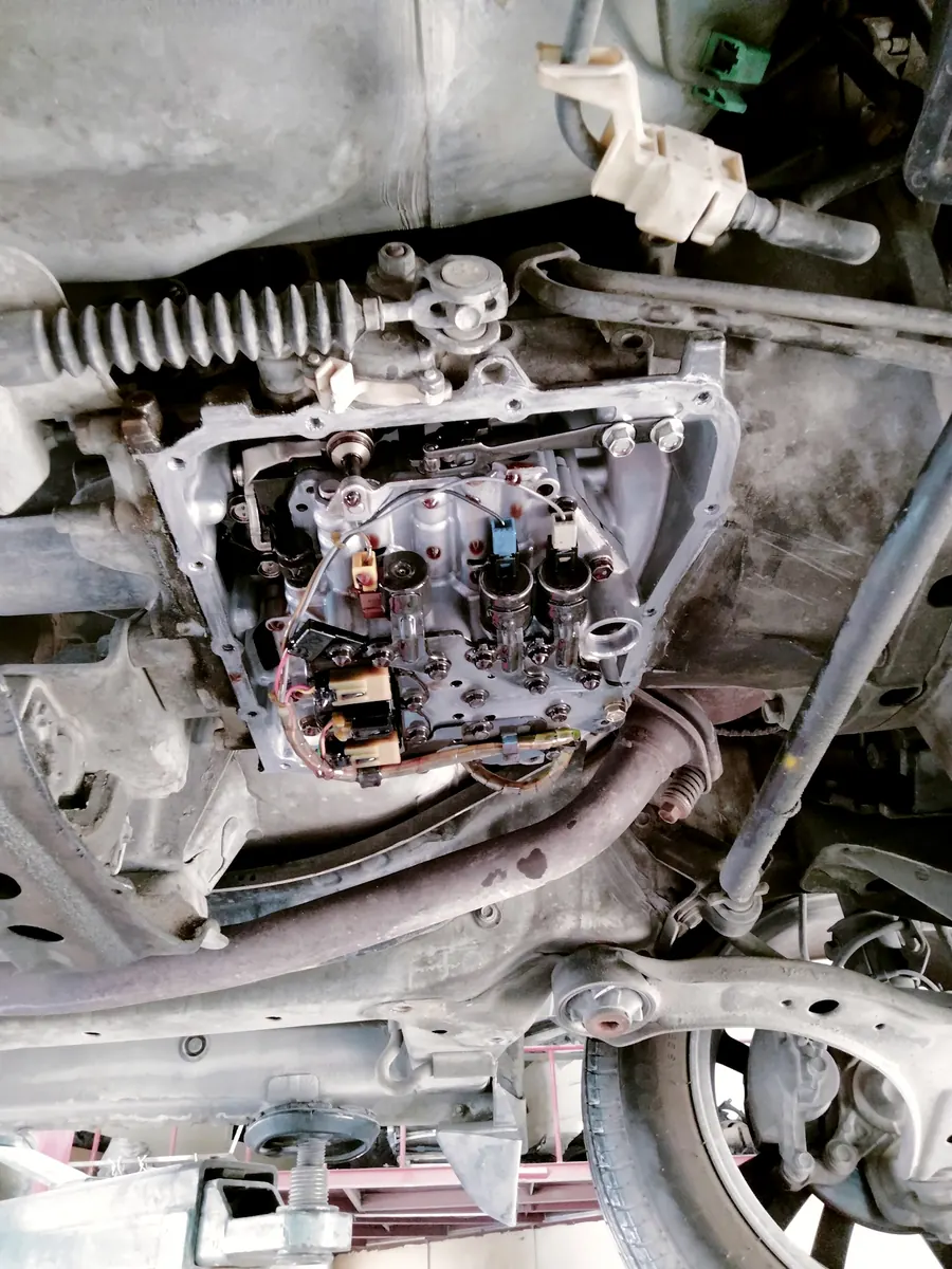 The underside of a car raised on the workshop lift